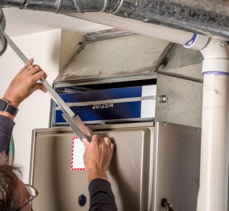 Removing panel of the modern furnace to replace the filter